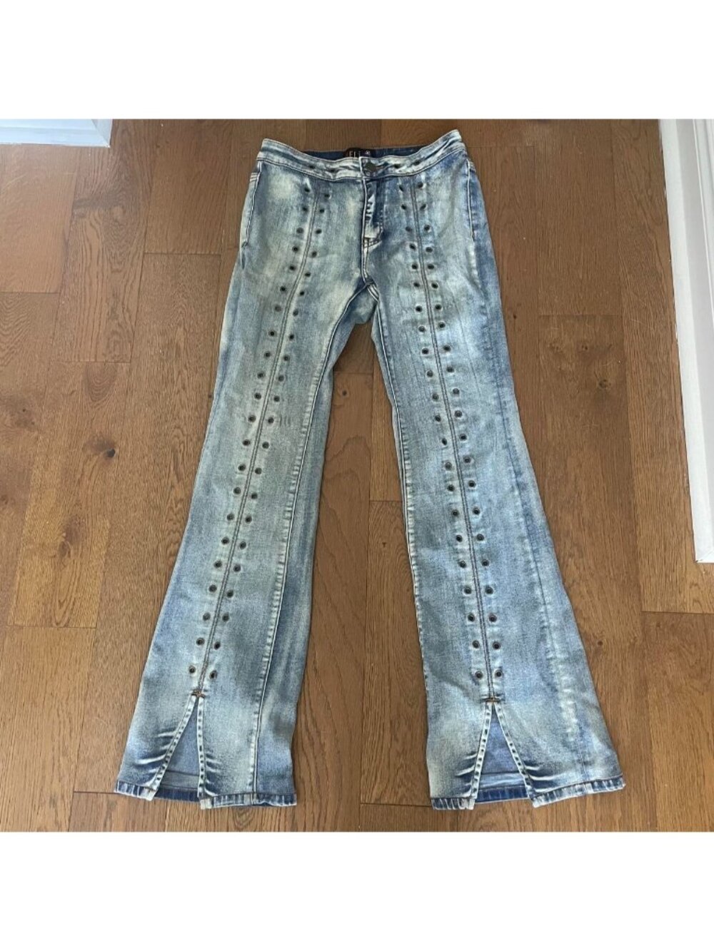 Delia's blue denim jeans with grommets and flared bottoms